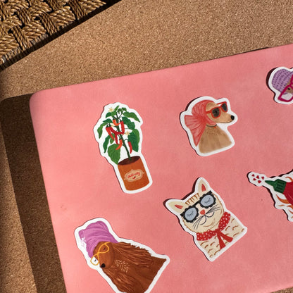 Pink laptop with decorative stickers on a textured surface
