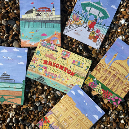 Set of postcards with illustrations of Brighton landmarks on pebbles.