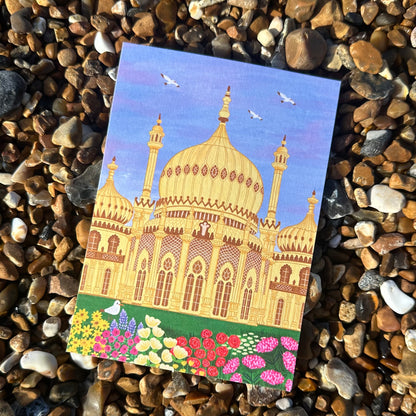 Colorful illustration of a mosque on a pebble surface