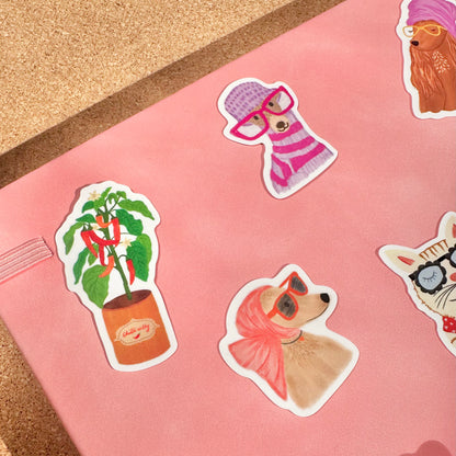 Sticker sheet with animal-themed stickers on a pink surface