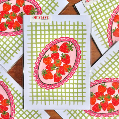 Notebook with strawberry design on a checkered background