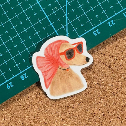 Hand drawn illustration vinyl Sticker of a dog with a pink head bow and sunglasses