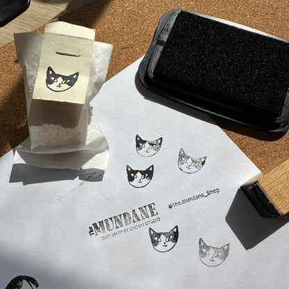 Cat-themed stamps on paper with a stamping tool