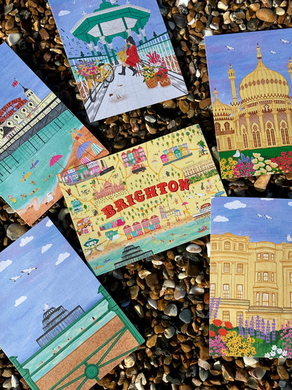 Collection of illustrated postcards featuring scenes from Brighton on a pebble background.