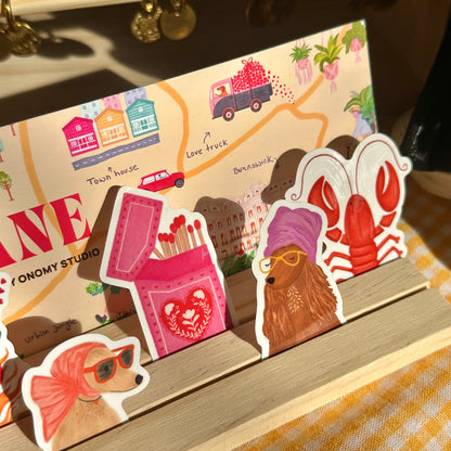 Set of illustrated paper cutouts on a stand with a colorful background