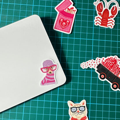 Stickers on a green cutting mat with grid lines