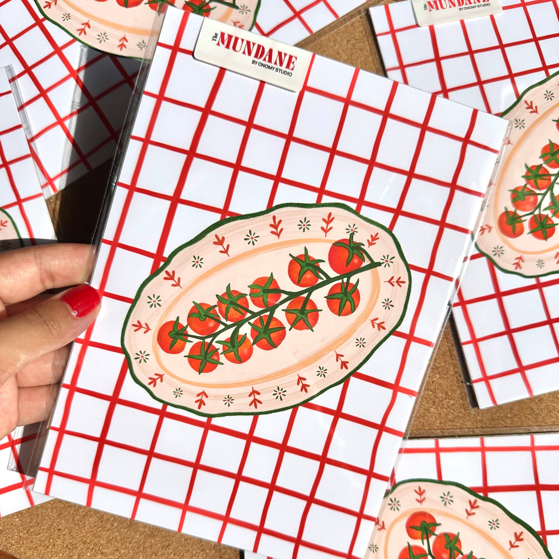 Notebook with tomato design on a red and white checkered background
