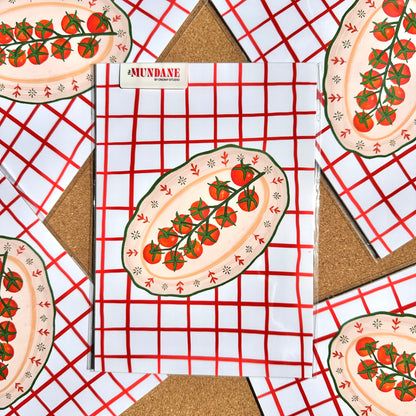 Notebook with tomato design on cover on a red and white checkered background
