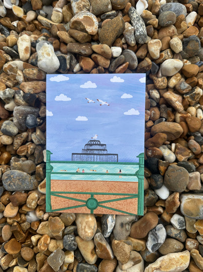 Small painting of a lighthouse on pebbles
