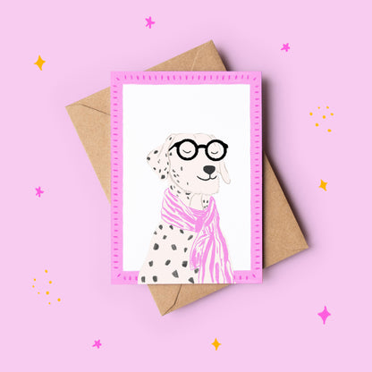 Greeting card with a dalmatian dog wearing glasses and a pink scarf, on a pink background with a brown envelope.
