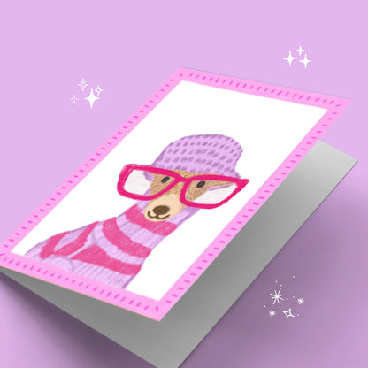 Card with a cartoon dog wearing pink glasses and a striped sweater on a purple background