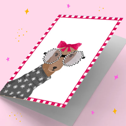Greeting card with a dog illustration wearing sunglasses and a bow on a pink background