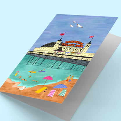 Yoga mat with an illustration of a pier and beach scene on a light blue background