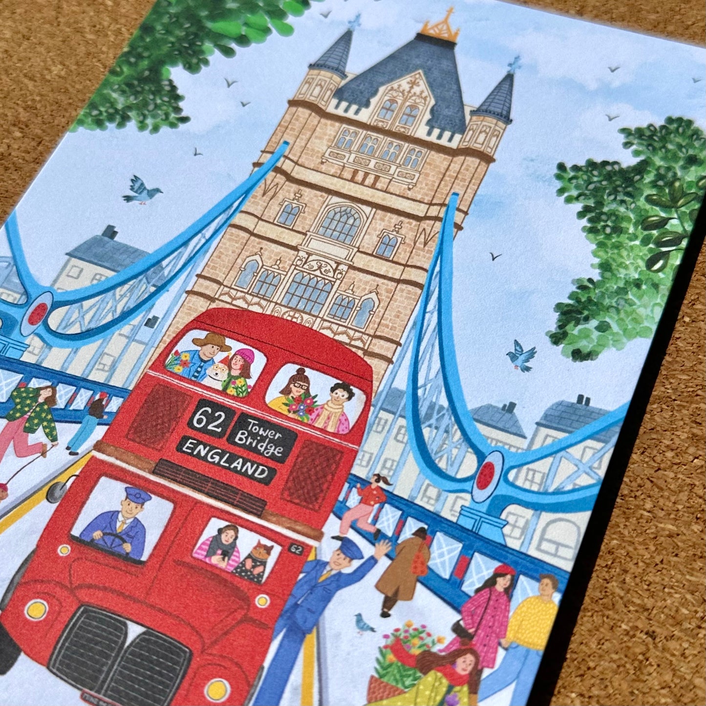 London gift for tourists, Tower Bridge illustrated postcard showing city scene with cyclists and Londoners
