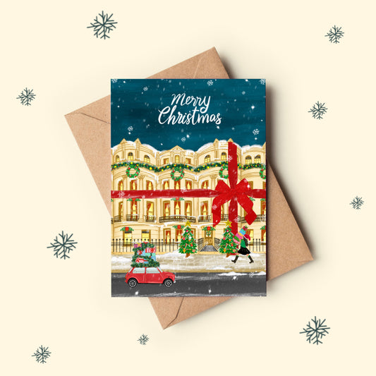 The mundane Brighton gift shop - Christmas card with a Brighton townhouse, car, and trees on a snowy street, featuring a red ribbon, Merry Christmas Greeting card  -  Gift for Christmas